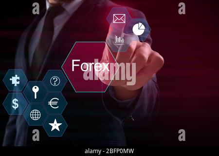 Financial trader working with virtual screen on dark background. Forex concept Stock Photo