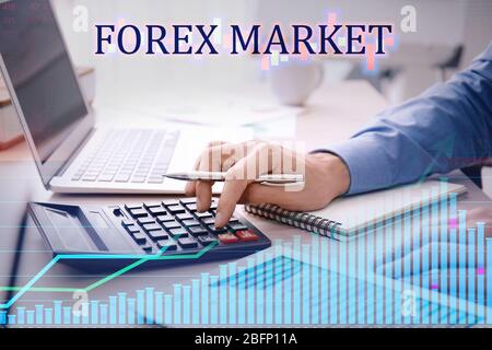 Double exposure of graphs and financial trader working at table in office. Forex concept Stock Photo
