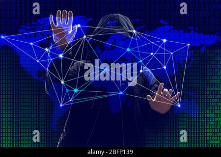 Hacker working with world map on virtual screen against dark background. Threat of global cyber attack Stock Photo