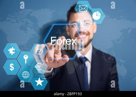 Financial trader working with virtual screen on color background. Forex concept Stock Photo