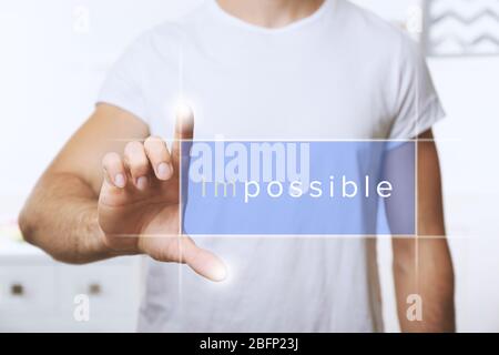 Human hand turning word impossible into possible Stock Photo