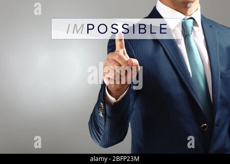 Human hand turning word impossible into possible Stock Photo