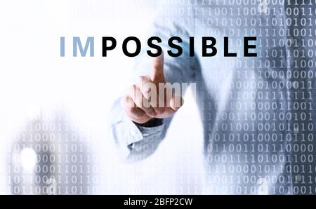 Human hand turning word impossible into possible Stock Photo