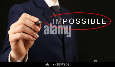 Human hand turning word impossible into possible Stock Photo