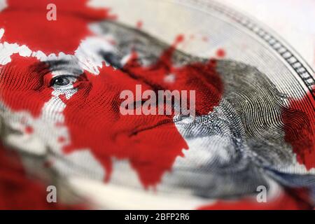 Dollar face and blood splashes close-up