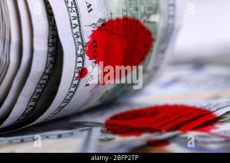 Twisted dollar banknotes with bloodstains, close up Stock Photo