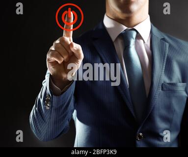 Finger press power button on virtual touch screen, modern technology concept Stock Photo