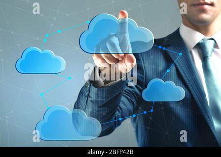 Hand pushing on virtual cloud. Cloud storage concept Stock Photo