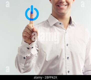 Finger press power button on virtual touch screen, modern technology concept Stock Photo