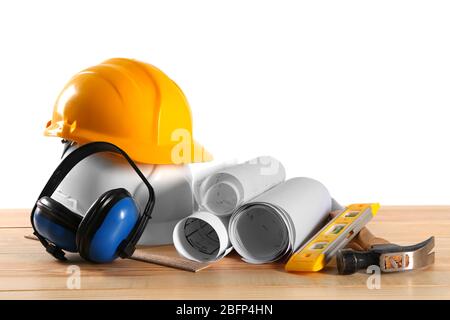 Construction drawings with tools on wooden table isolated on white background Stock Photo
