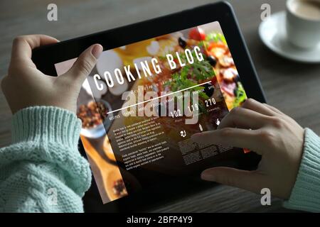 Female hands with tablet. Cooking blog concept Stock Photo