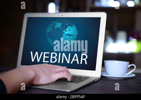 Woman's hand typing on net book at the table. Webinar concept Stock Photo