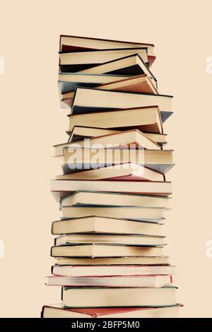 High stack of books on light background Stock Photo