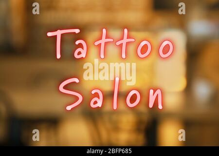 Text Tattoo Salon on blurred background Stock Photo