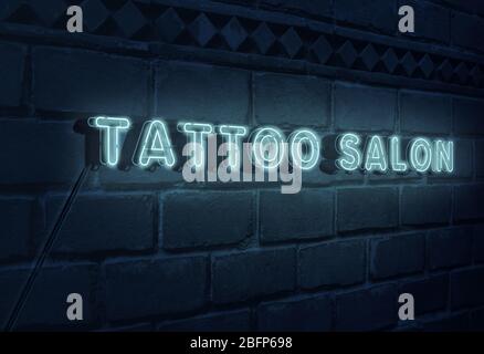 Sign Tattoo Salon on brick wall background Stock Photo