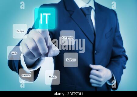 Businessman in suit pushing button on virtual screen. IT technologies concept. Stock Photo