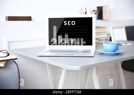 SEO technology concept. Modern workplace interior. Stock Photo