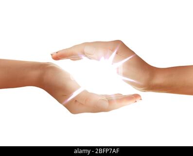 Female hands holding light on white background. Stock Photo