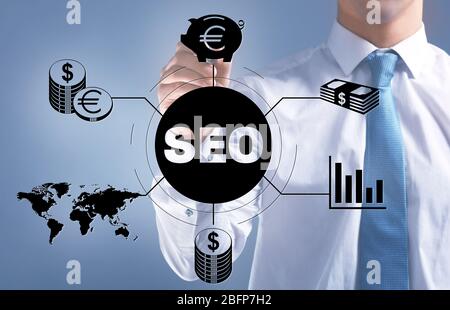 Businessman push button on virtual screen. SEO technology Stock Photo