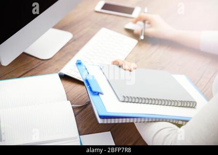 Clipboard and notebook in woman hands Stock Photo