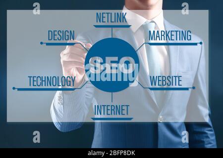 Businessman working with virtual touchscreen. SEO technology concept. Stock Photo