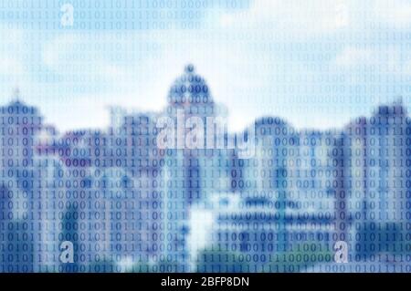 Binary code on blurred cityscape background. Stock Photo