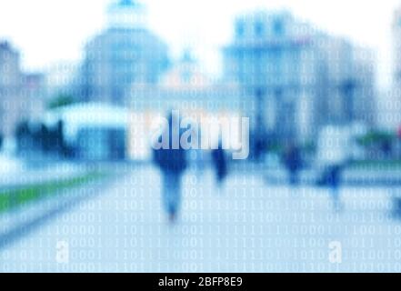 Binary code on blurred city street background. Stock Photo