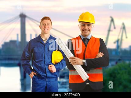 Young male construction engineers on blurred city background Stock Photo
