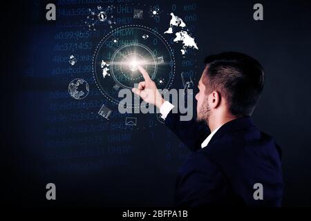 Businessman working with virtual touchscreen. Virtual button on display. Technology concept. Stock Photo