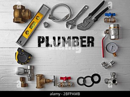 Plumbing concept. Plumber tools frame on white wooden background Stock Photo