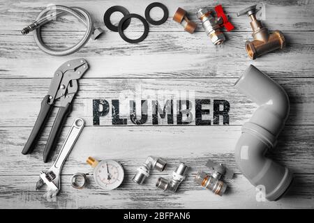 Plumbing concept. Plumber tools frame on wooden structure background Stock Photo