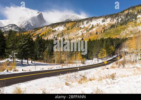 12,713 ft. Hallet Peak and 12,324 ft. Flattop Mountain a scenic paved road takes visitors through the rich scenery of an early autumn snow storm. Stock Photo