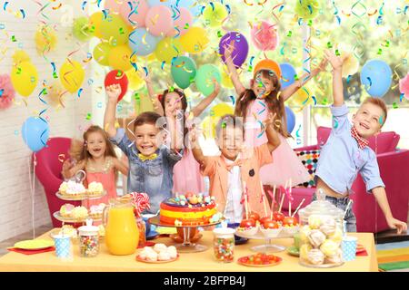 Children's funny birthday party in decorated room Stock Photo