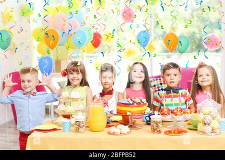 Children's funny birthday party in decorated room Stock Photo