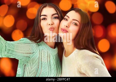 Young woman taking selfie on blurred background. Stock Photo