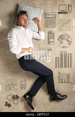 Young man sleeping on carpet. Business icons on textured background. Stock Photo