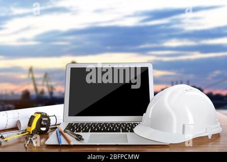 Laptop with construction tools on blue sky background Stock Photo