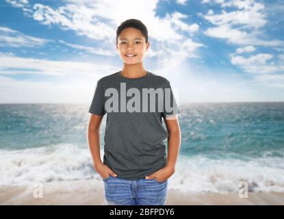 African-American boy in stylish t-shirt on landscape background Stock Photo