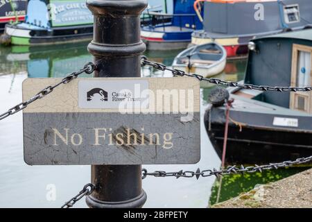 No Fishing Sign from the Canal and River Trust with boats moored in the background at Limehouse Basin Marina, Tower Hamlets, East London, UK. Stock Photo