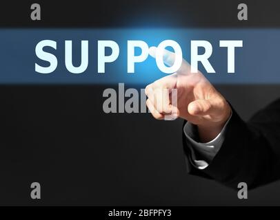 Support concept. Man pointing on text against black background, closeup Stock Photo