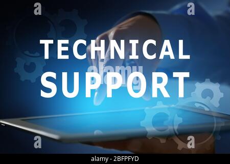 Technical support concept. Man working with tablet, closeup Stock Photo