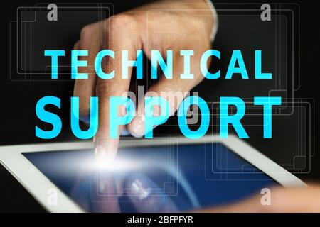 Technical support concept. Man working with tablet, closeup Stock Photo