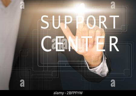 Help desk concept. Man pointing on text SUPPORT CENTER, closeup Stock Photo