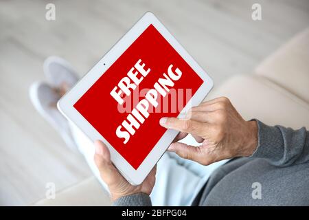 Delivery concept. Senior man using tablet at home Stock Photo