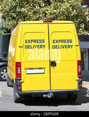 Delivery concept. Service van parked near sidewalk Stock Photo