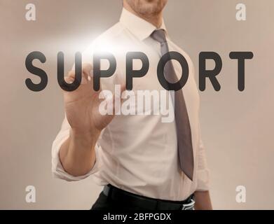 Support concept. Man pointing on text against color background Stock Photo
