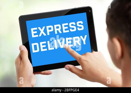 Delivery concept. Man using tablet, closeup Stock Photo
