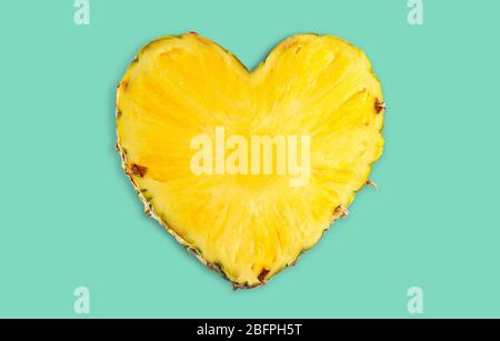 Heart shaped pineapple on color background. Superfood concept Stock Photo