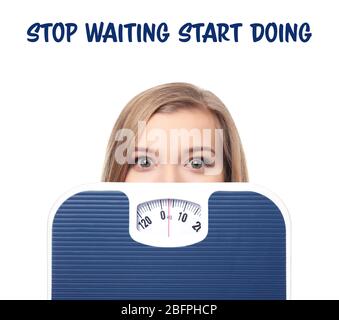 Weight loss motivation concept. Young woman with scales and text STOP WAITING START DOING on white background Stock Photo