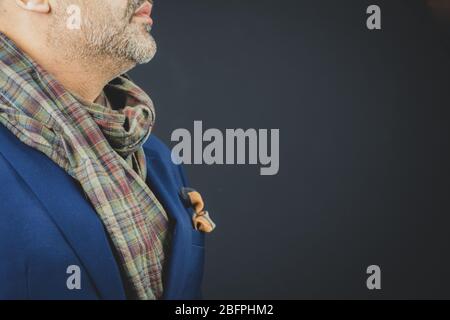 Stylish man smartly dressed in a scarf and suit. Stock Photo